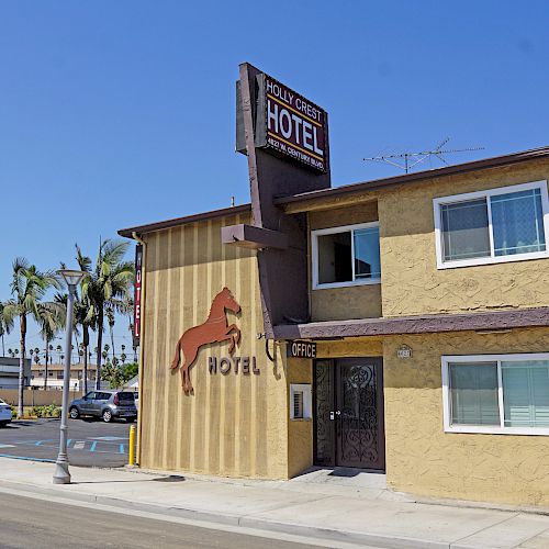 A small hotel with a horse logo on its facade, sign reading 